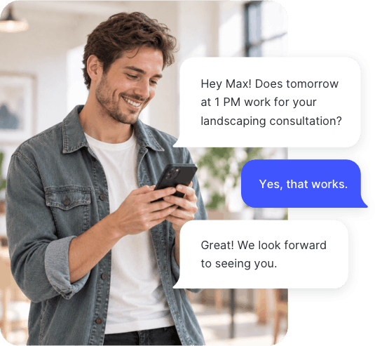 Man smiling at his phone while confirming a landscaping consultation appointment with a business over text